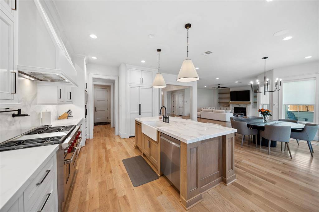 Chef's Kitchen offers an Apron-front sink, stainless steel dishwasher, 48" Wolf Range, Bosch Coffee Maker, Panel-Front fridge & Butler's Pantry.