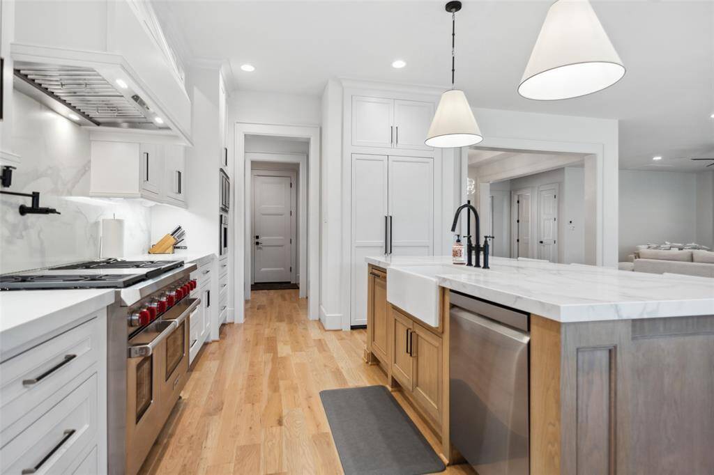 48" Wolf Range w/ double oven/Vent hood, pot filler & Custom Site-built cabinetry.