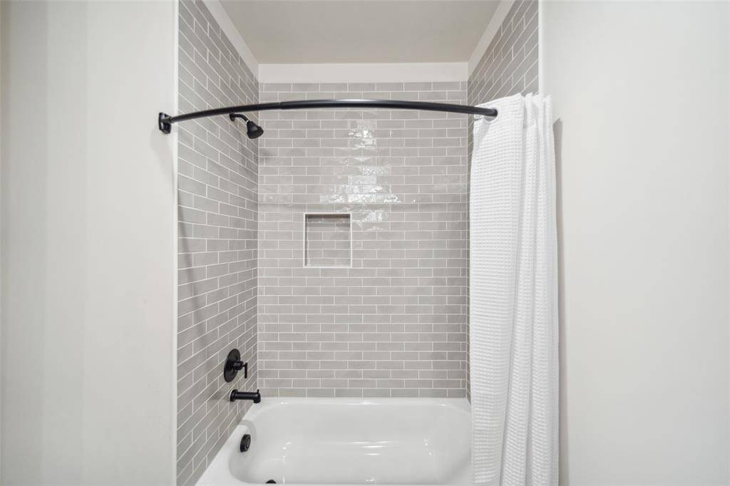 Each bathroom has it's own unique designer tile surround.