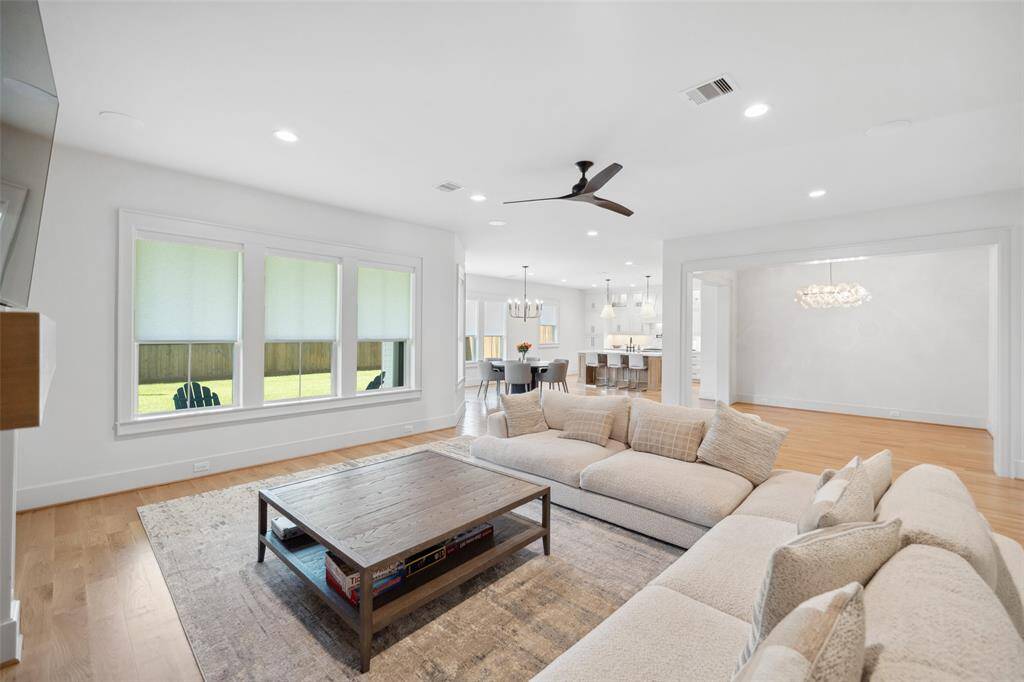 Open floor plan with white oak wood floors throughout w/ tall ceilings & Designer selected finishes