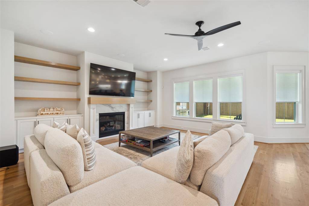 The Family Room is a generous size w/ large windows letting in natural light & gas fireplace w/ custom built-ins on either side. Perfect for entertaining.