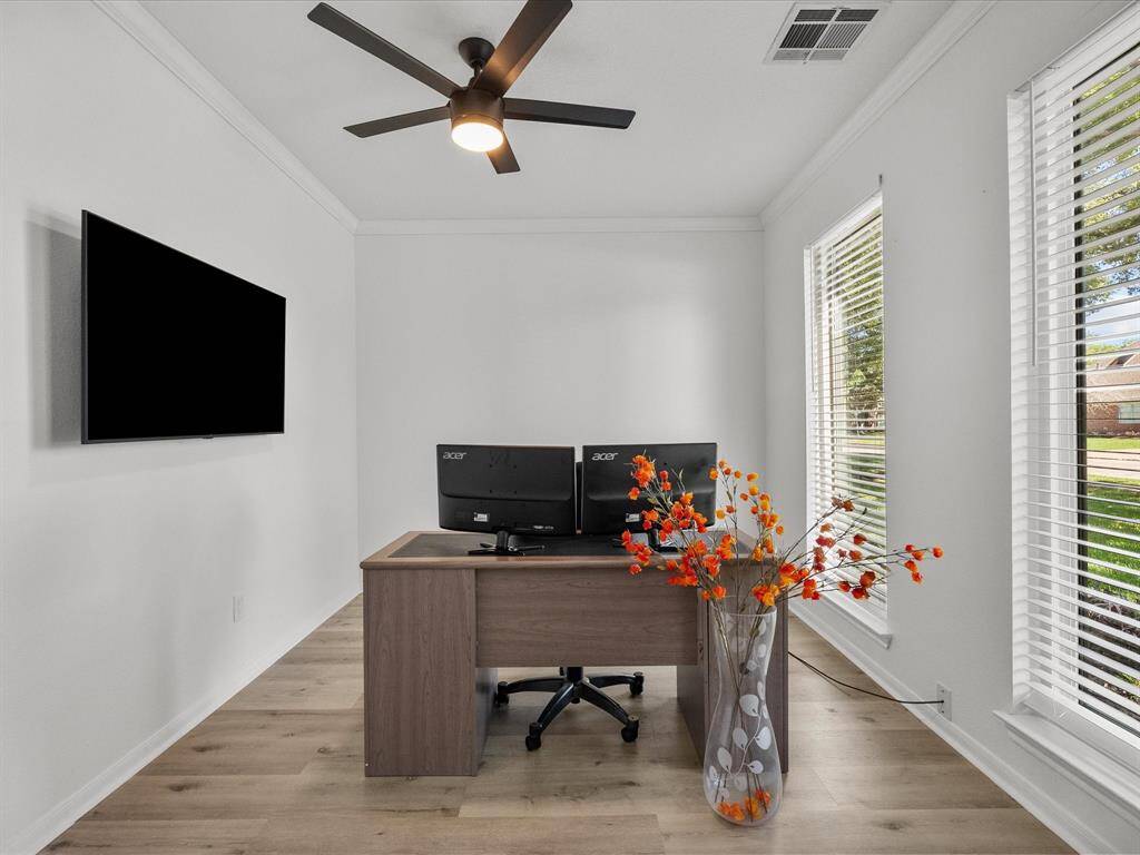 Bright and airy home office with large windows, new remote controlled ceiling fan and modern barn doors to elegantly close off this space when needed for your next meeting.