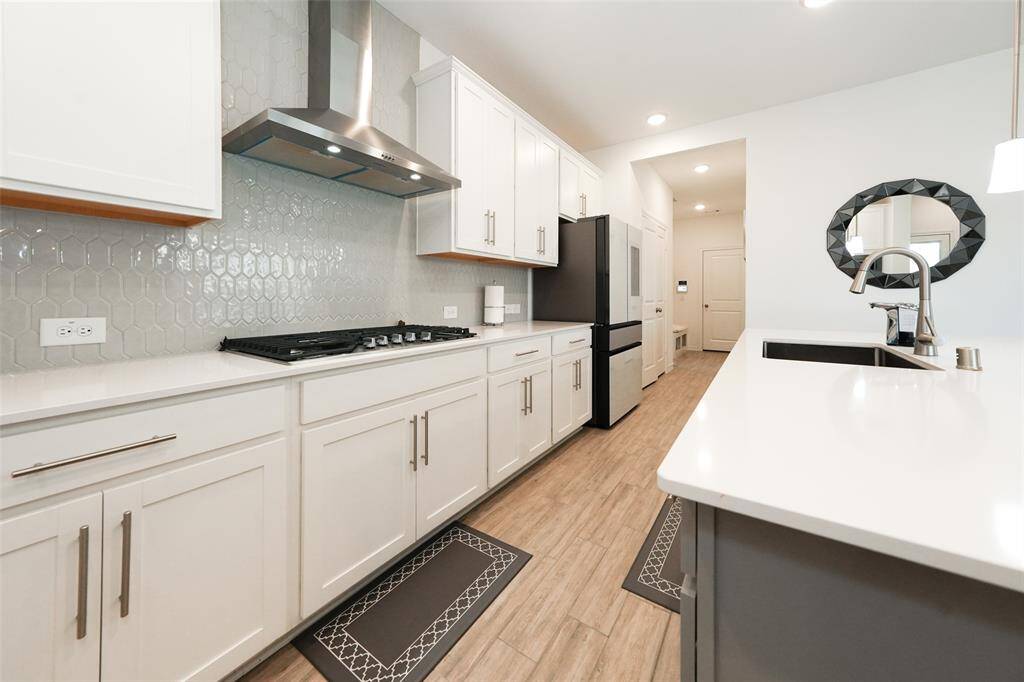 Cook in style with a 5-burner gas stove and an elegant designer exhaust vent above.