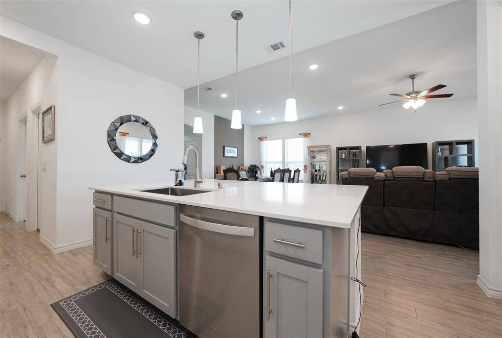 Share the joy of cooking with family in this kitchen, with direct access to both the dining and living rooms for effortless flow.
