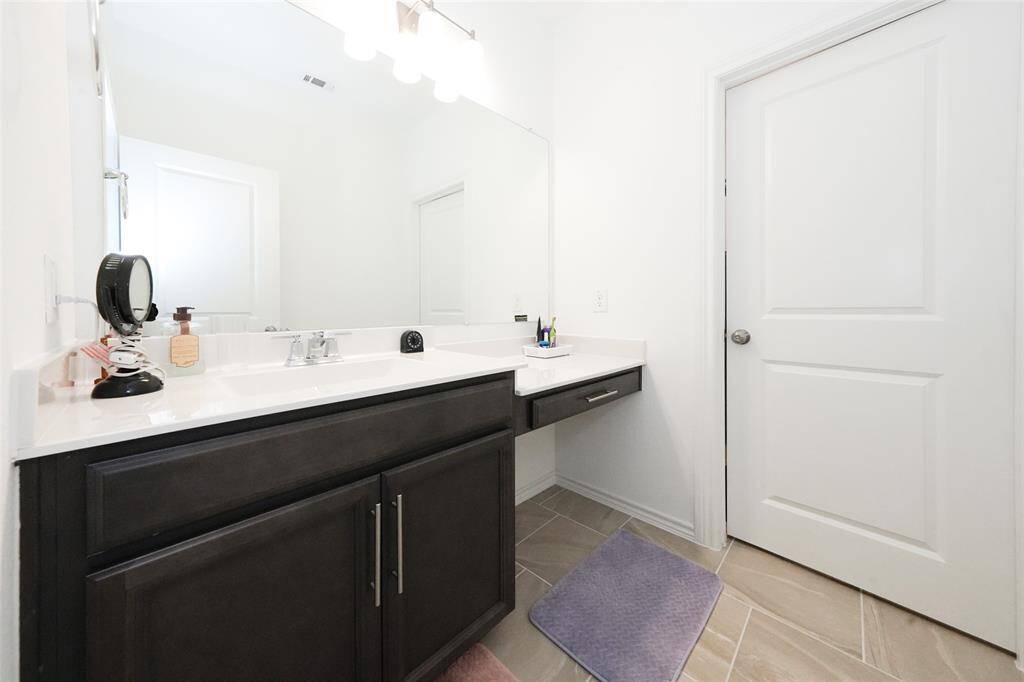 This upstairs full bathroom is perfectly located for two bedrooms to share, adding ease and comfort to daily routines.
