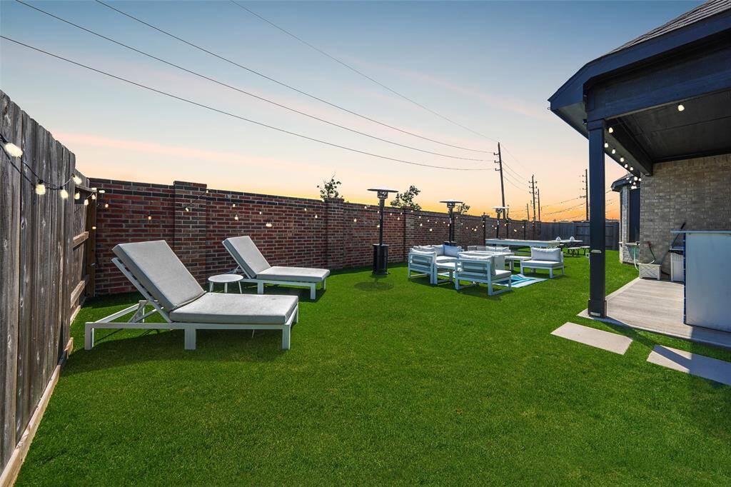 Spacious backyard with turf for year-round greenery and zero mowing hassle—perfect for play and relaxation!