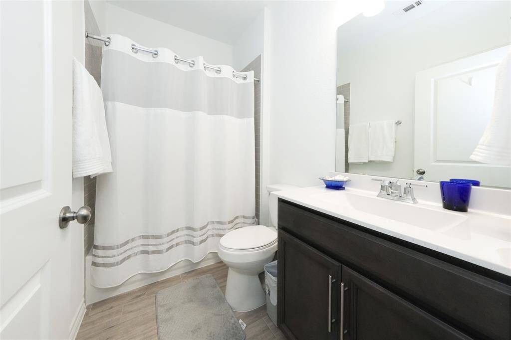Conveniently positioned guest bathroom on the main floor, right next to the guest room for added privacy and ease.