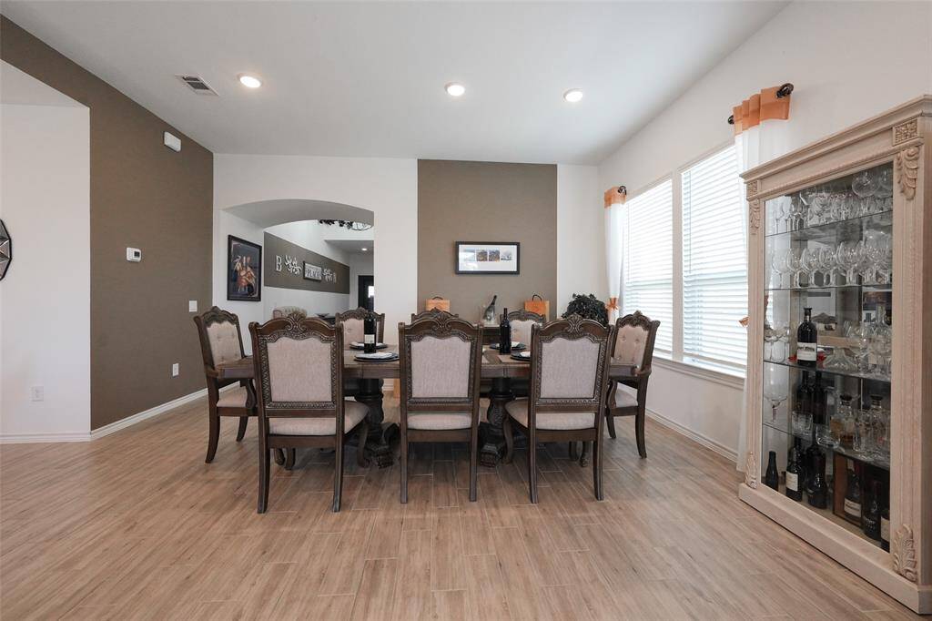 Expansive dining area easily accommodates a large table for 8, perfect for gatherings and entertaining.