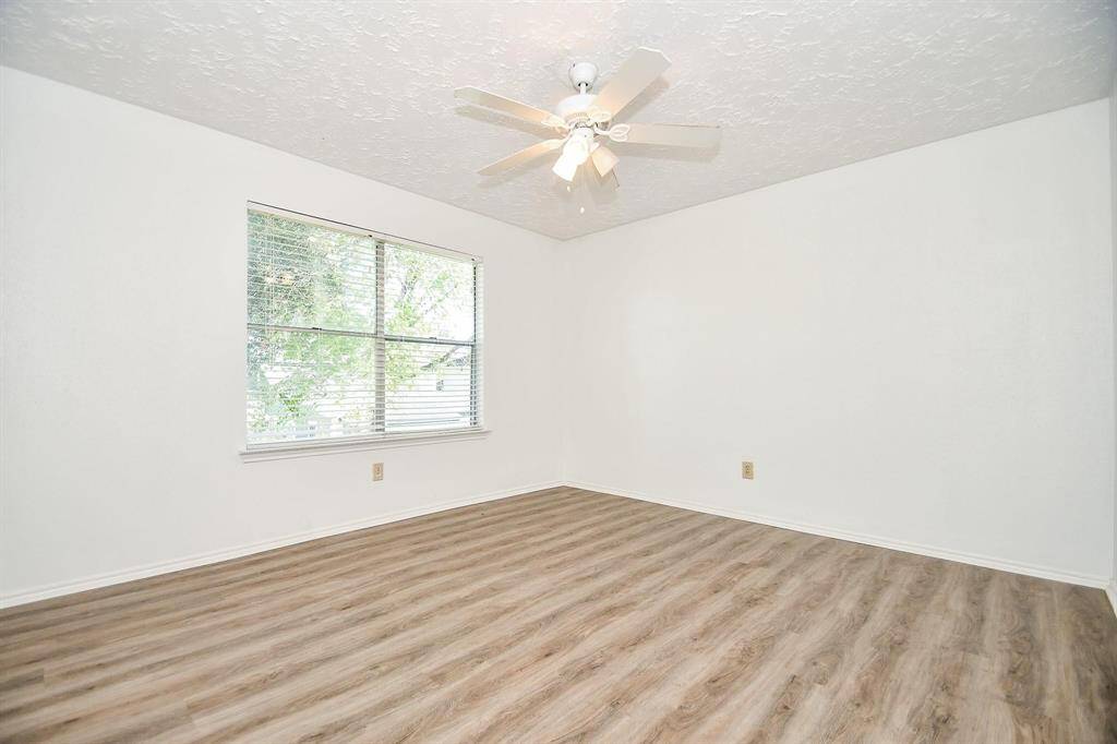 Third bedroom with ceiling fan and natural light