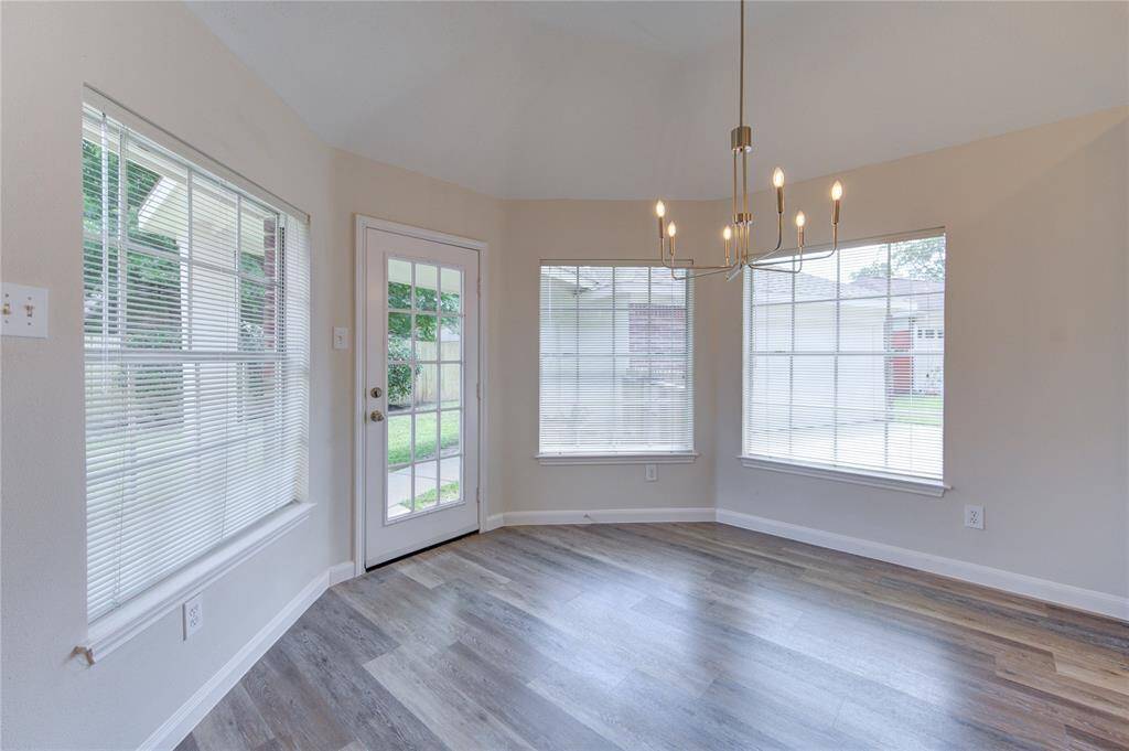 A roomy breakfast area with plenty of natural light and new chandelier.