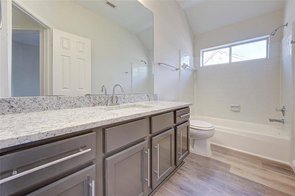 Secondary bath has new granite, sink, faucet, light fixtures, and stylish cabinet door pulls!