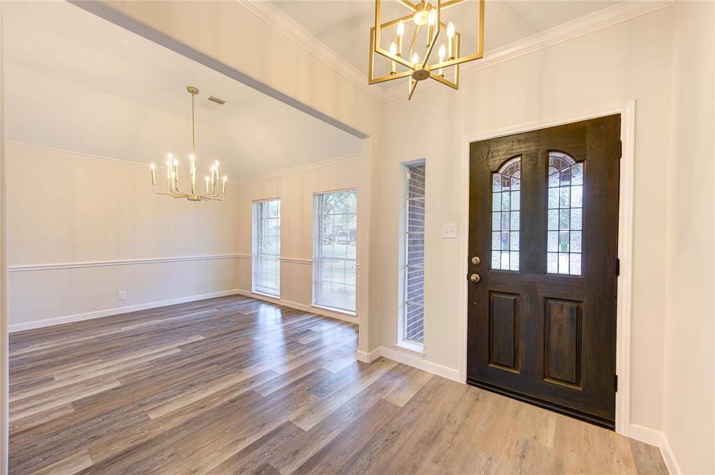 Foyer and formal dining areas has chick, stylish satin gold fixtures.