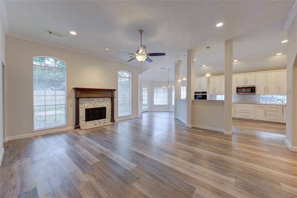 The spacious family room is large, has high ceilings, and is open to the kitchen.  All new LED recessed lighting has been installed throughout.  The home is bright and airy and very welcoming.  The fire place has a new ledger stone tiled surround.