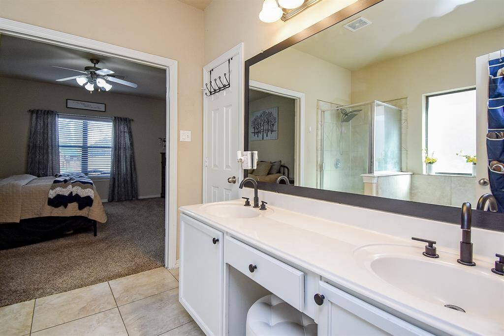 Double sinks, and door to theleft leads to restroom.