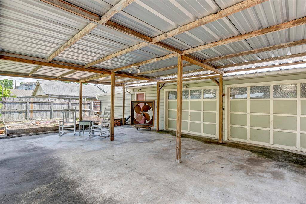 Large carport in front of garage.