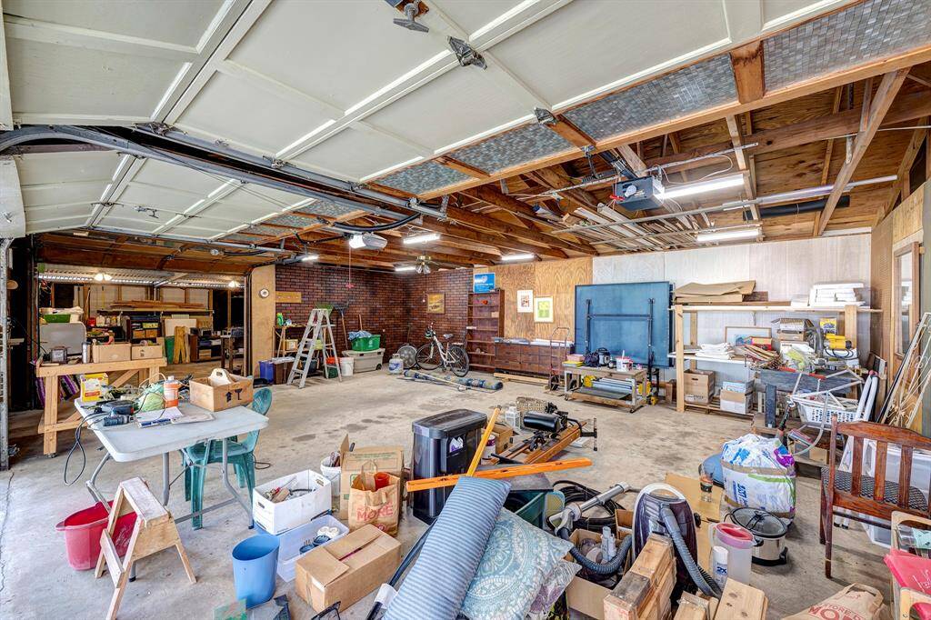 Large oversized three car garage with two doors.