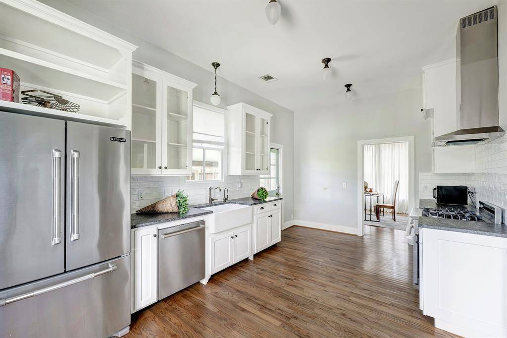View of kitchen towards rear door of house.