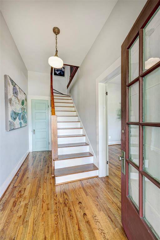 Entryway with stairs and coat closet.