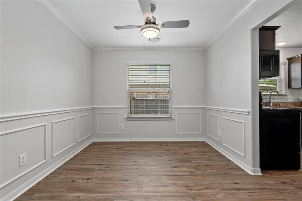 Elegant formal dining room featuring stylish wainscoting.