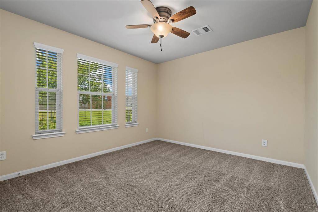 Discover a versatile front secondary bedroom, perfectly secluded for a quiet home office.