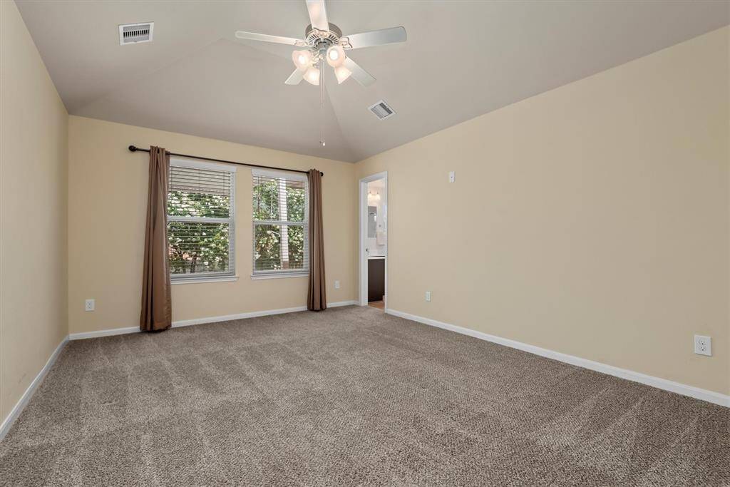 Primary bedroom feels even more spacious with high ceilings.