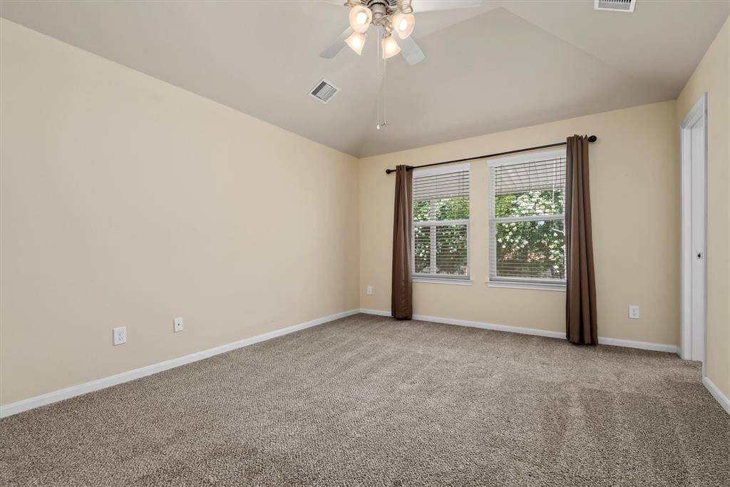 Owners retreat features windows facing the backyard.