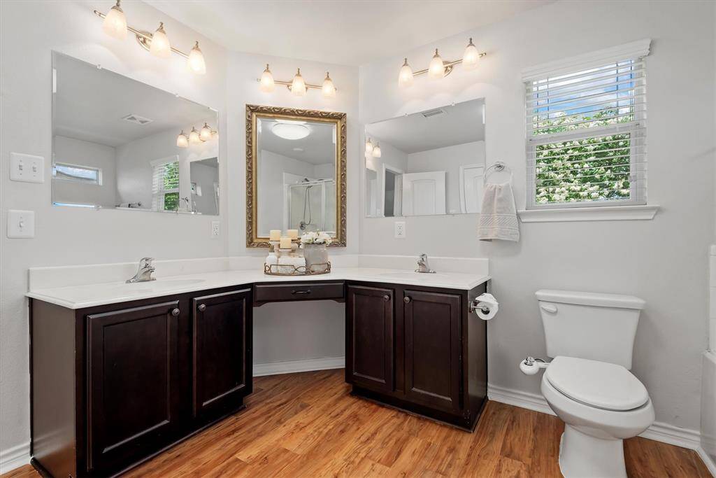 Light and bright bathroom with updated light fixtures.