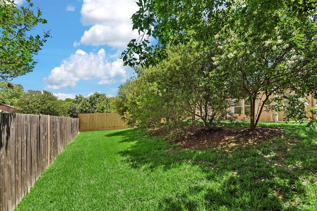 Backyard gently slopes away from the house.