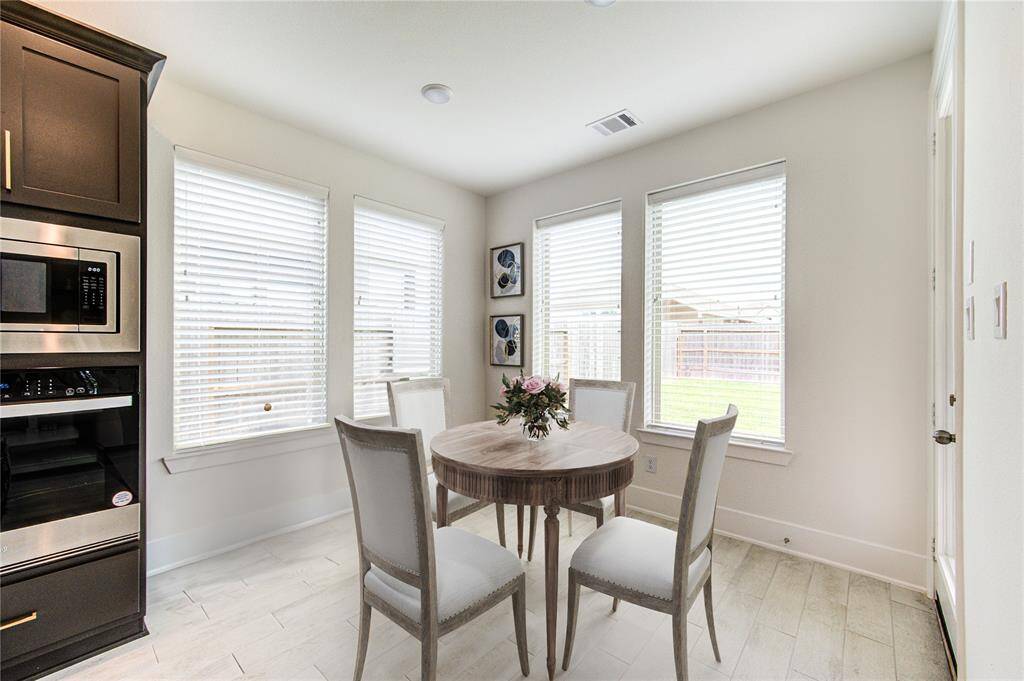 Bright and inviting breakfast room, beautifully virtually staged for a warm start to your day.