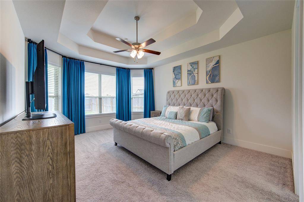 Experience serene comfort in the primary suite, featuring custom blackout drapes for ultimate privacy.