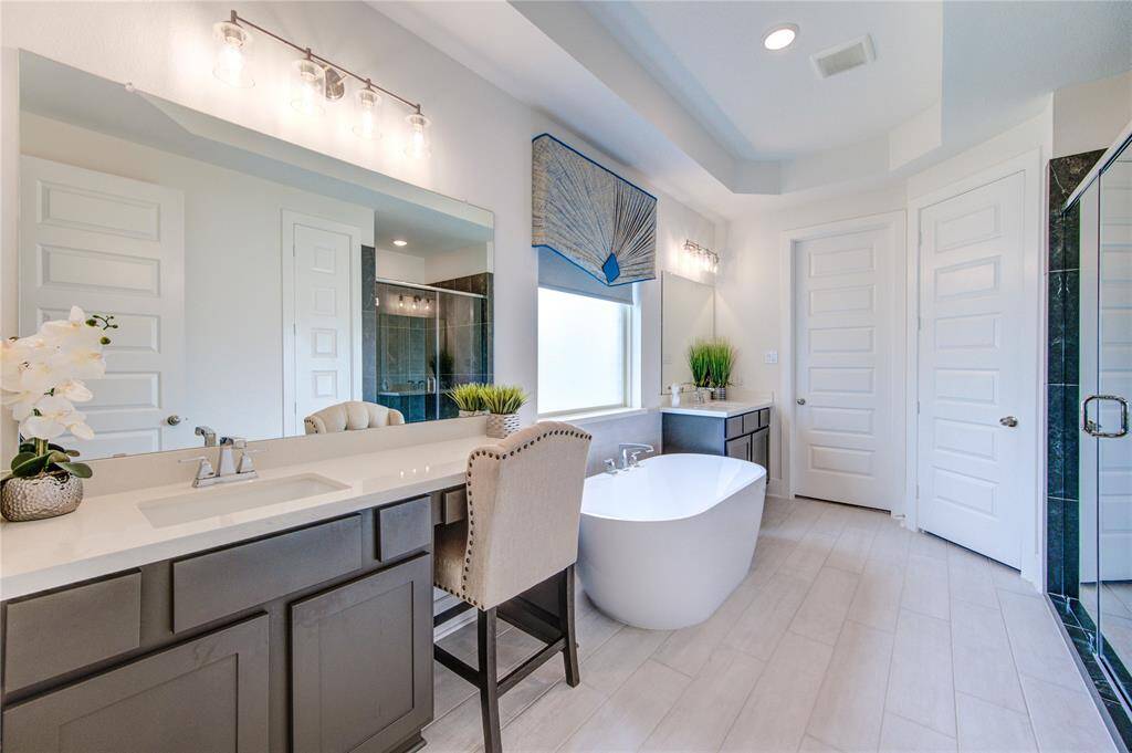 Luxurious primary bath with elegant double sinks.