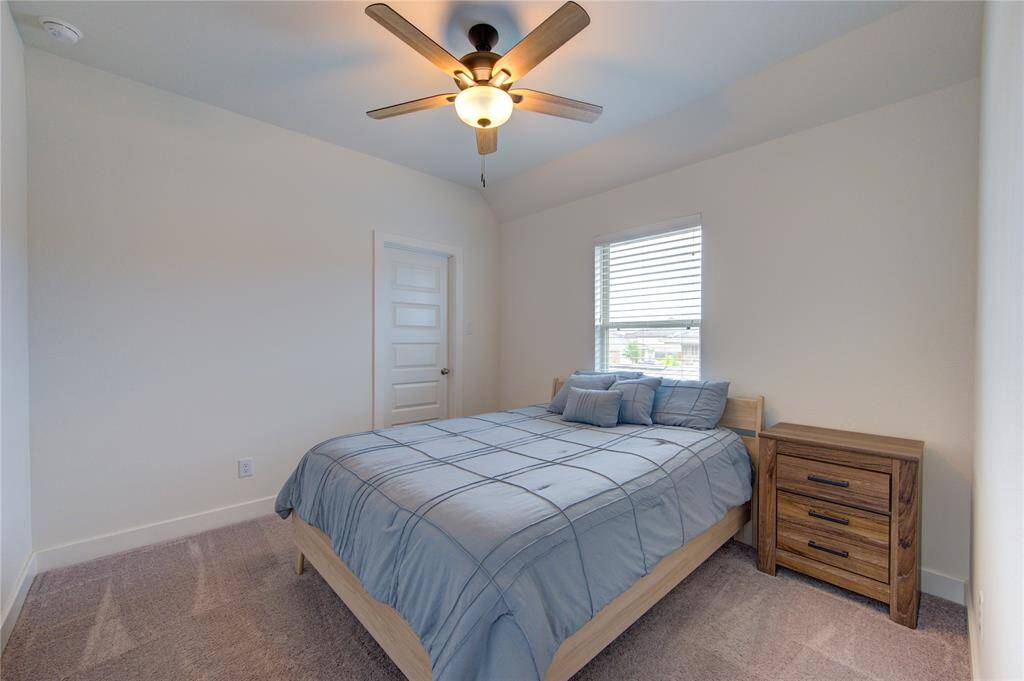 Cozy bedroom with natural light and custom shutters.
