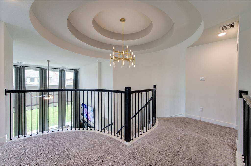 Experience breathtaking views from the upper balcony, complemented by stunning ceiling details throughout the home.