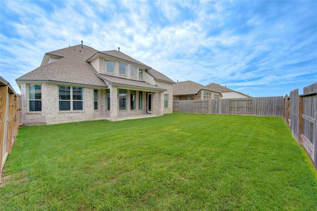 Fully fenced yard with a covered patio