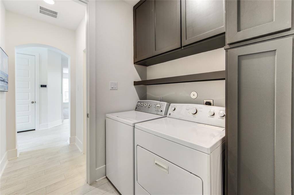 Expansive laundry room with ample storage.