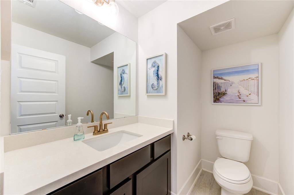 Convenient and stylish downstairs half bath with modern fixtures and elegant decor.