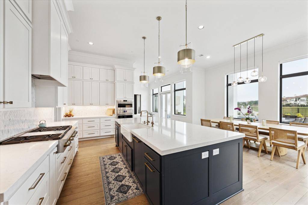 The oversized island features dual dishwashers and abundant seating, perfect for both meal preparation and entertaining.