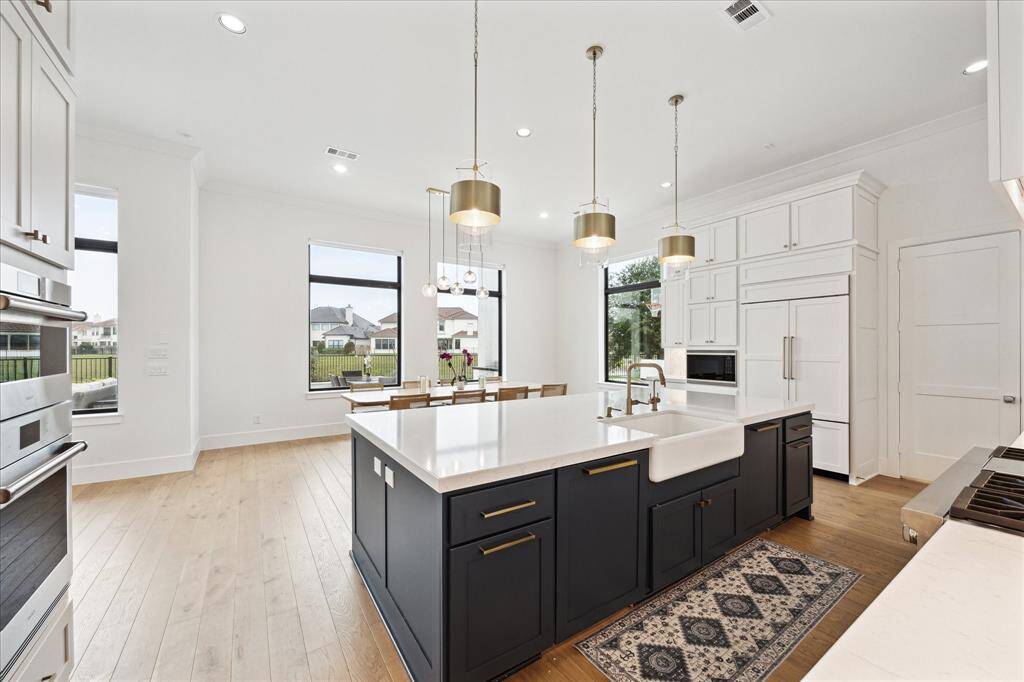 Featuring premium Wolf steam and convection ovens, the kitchen provides top-tier cooking performance with a touch of elegance.