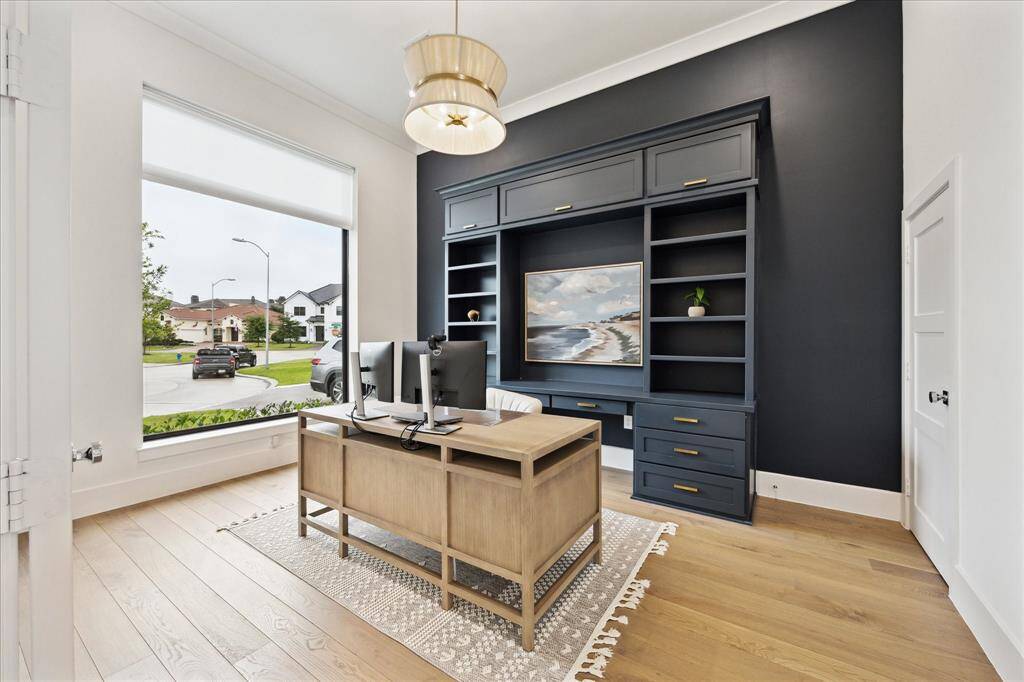 The dedicated office features custom built-ins and a spacious storage area (behind the door).