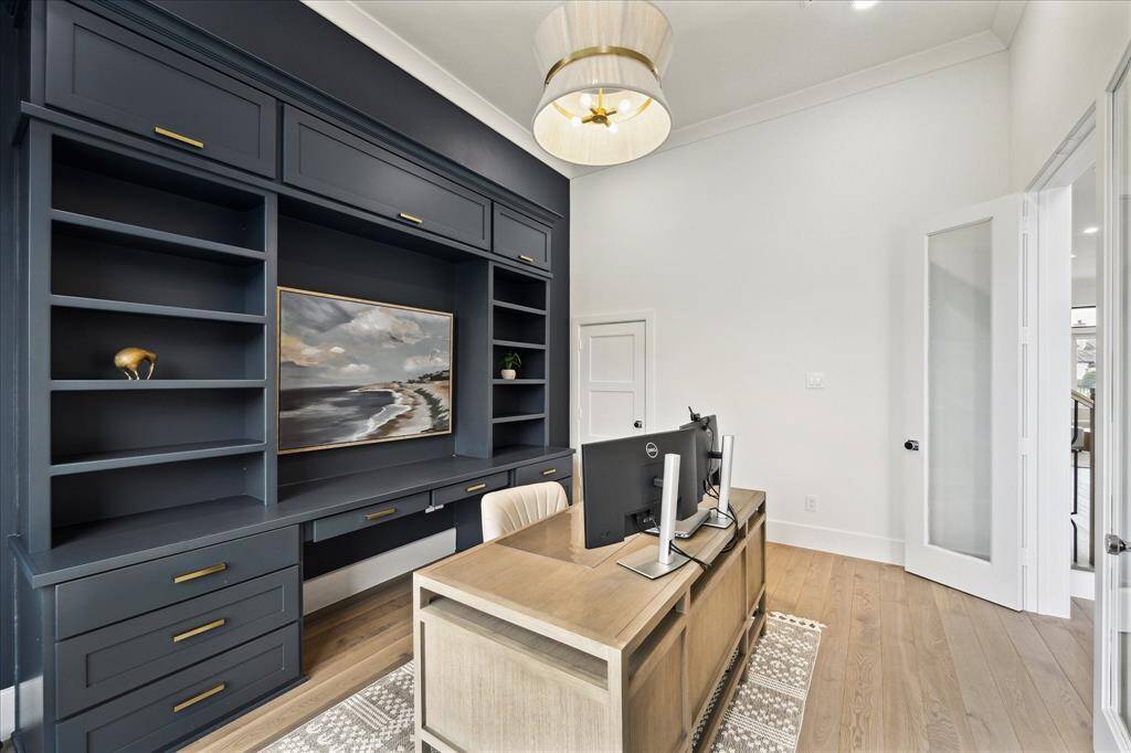 The office is adorned with elegant French doors and custom designer paint for a polished, sophisticated touch.