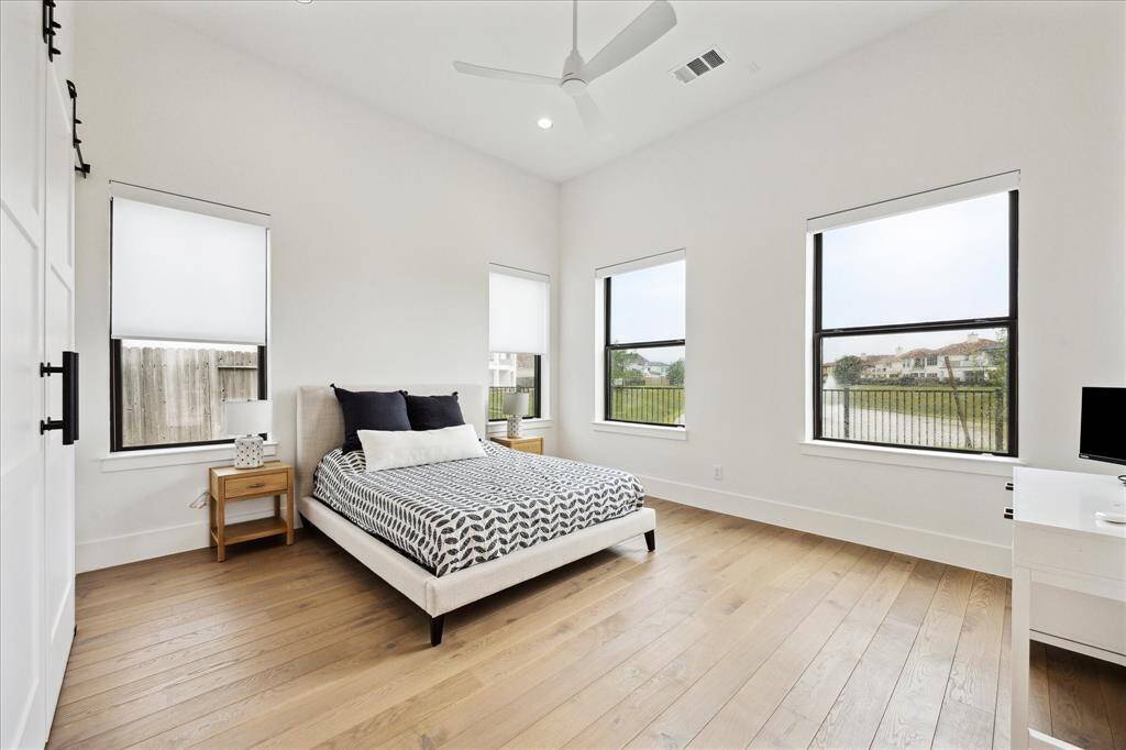 A convenient first-floor suite offers a private bath and walk-in closet—perfect for guests or multigenerational living, with no need to climb stairs.