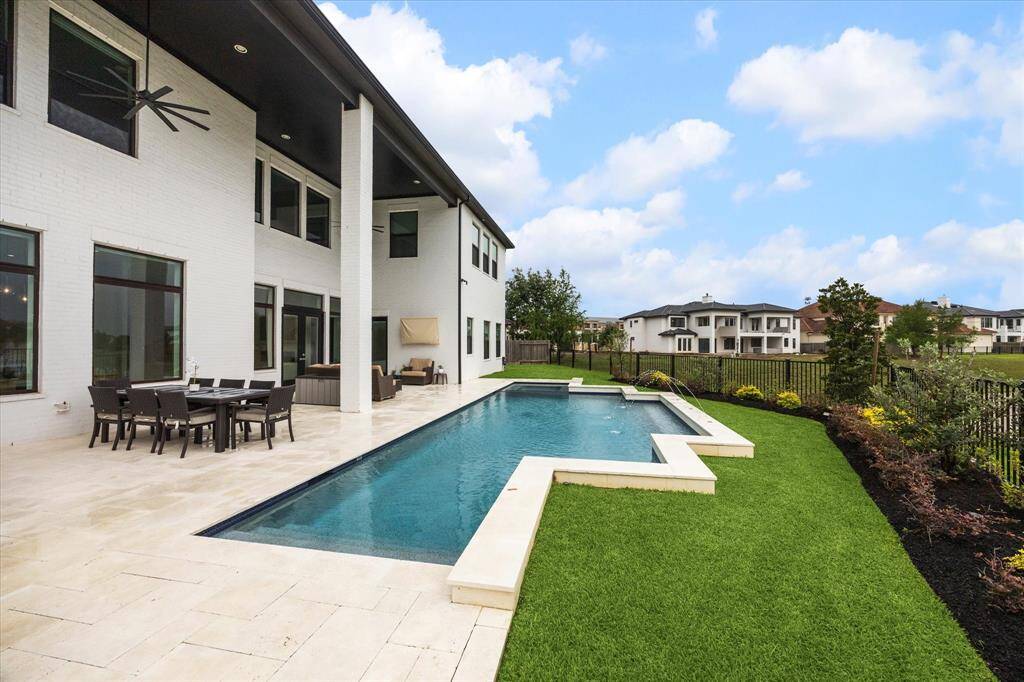 The expansive covered patio is equipped with a mosquito misting system, ensuring  comfort while enjoying the outdoors.
