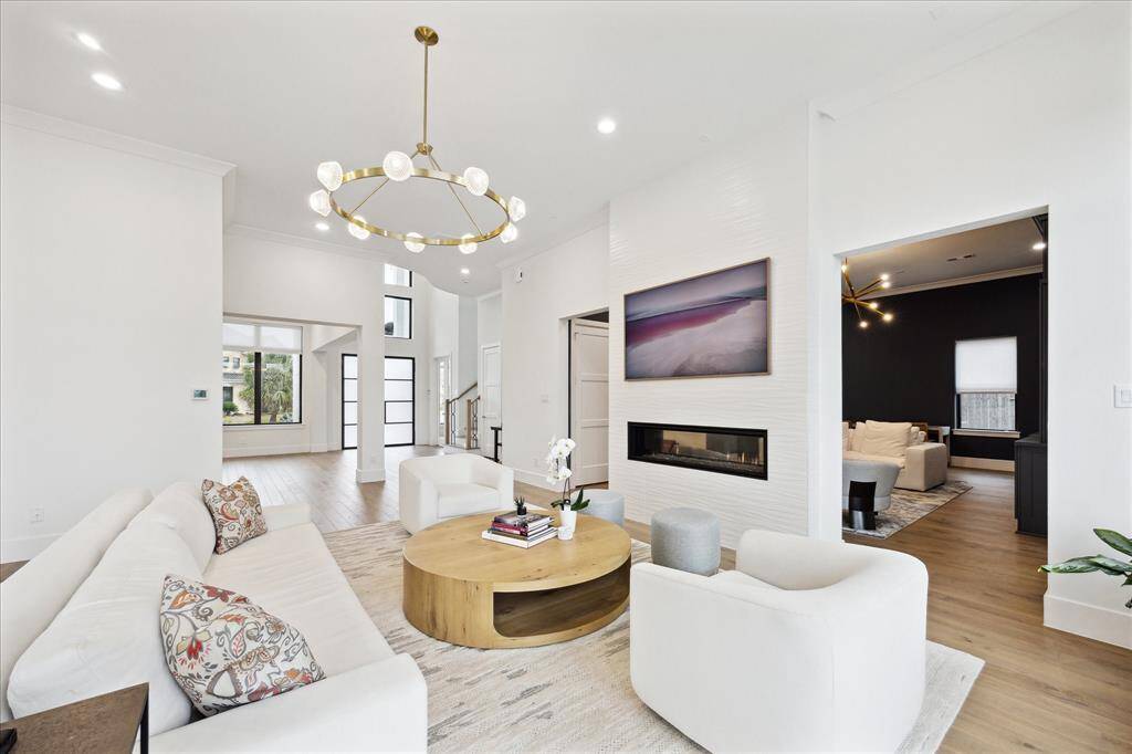 A striking dual-sided 5-foot fireplace is framed by a stylish tiled wall, adding elegance and warmth.