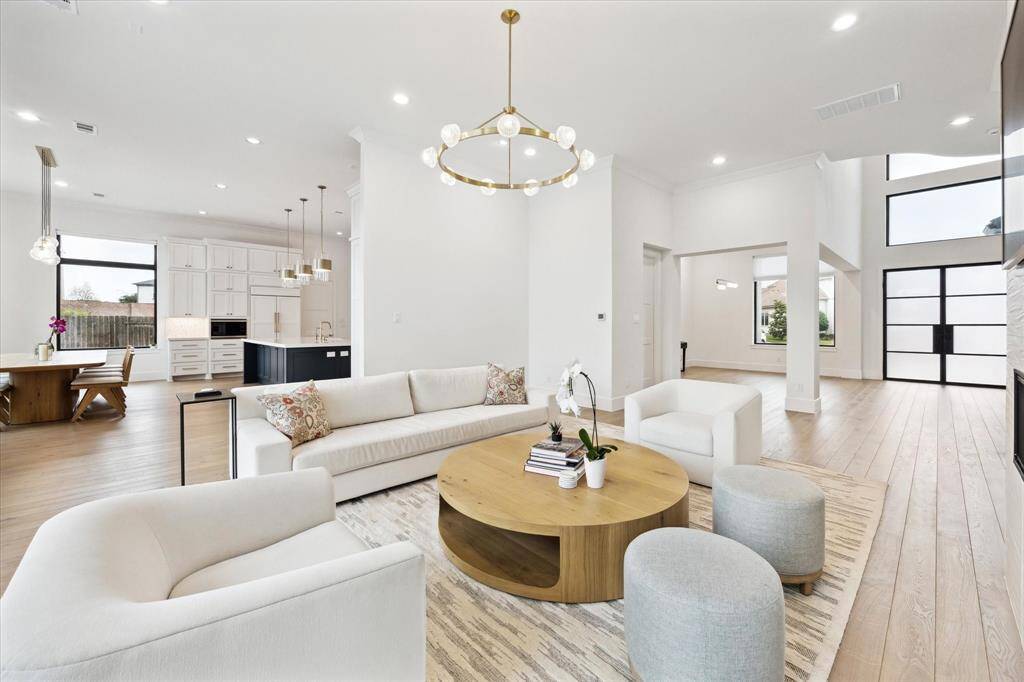 The living room flows seamlessly into the breakfast area and kitchen, creating a spacious and inviting open-concept layout.