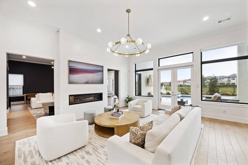 The living room offers a view into the spacious family room and a conveniently located first-floor suite.