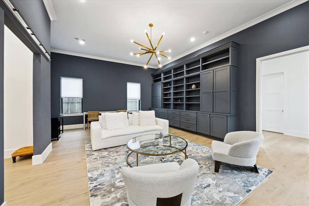 The family room is enhanced with  a designer chandelier, and exquisite crown molding. It also offers a bonus flex space. Right outside the window a nectarine tree is bearing fruit!