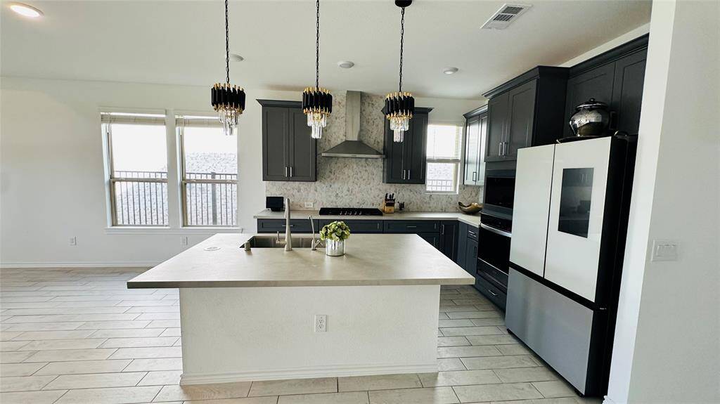 spacious kitchen with island and luxury appliances