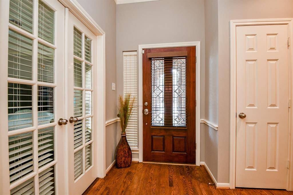 Foyer and first guest bedroom opened up with glass French doors.