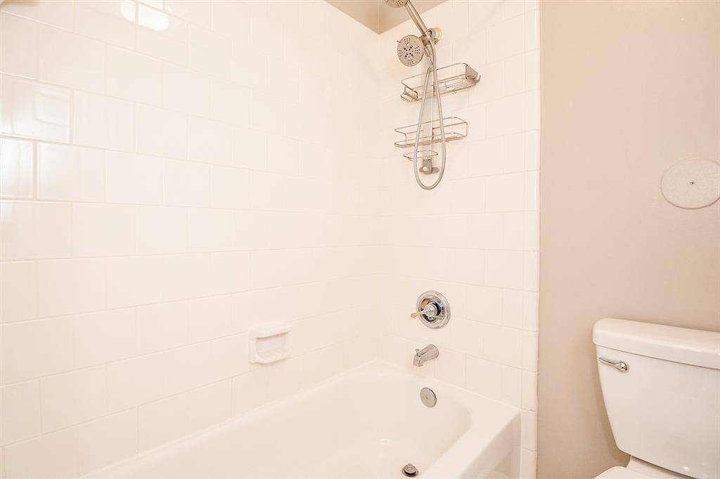 Guest bathroom with tub/shower combo and one sink.