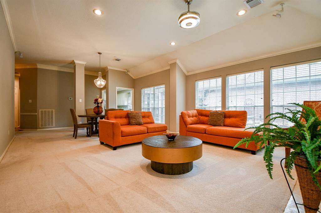 Another view of the spacious, well lit, high ceilings family room.